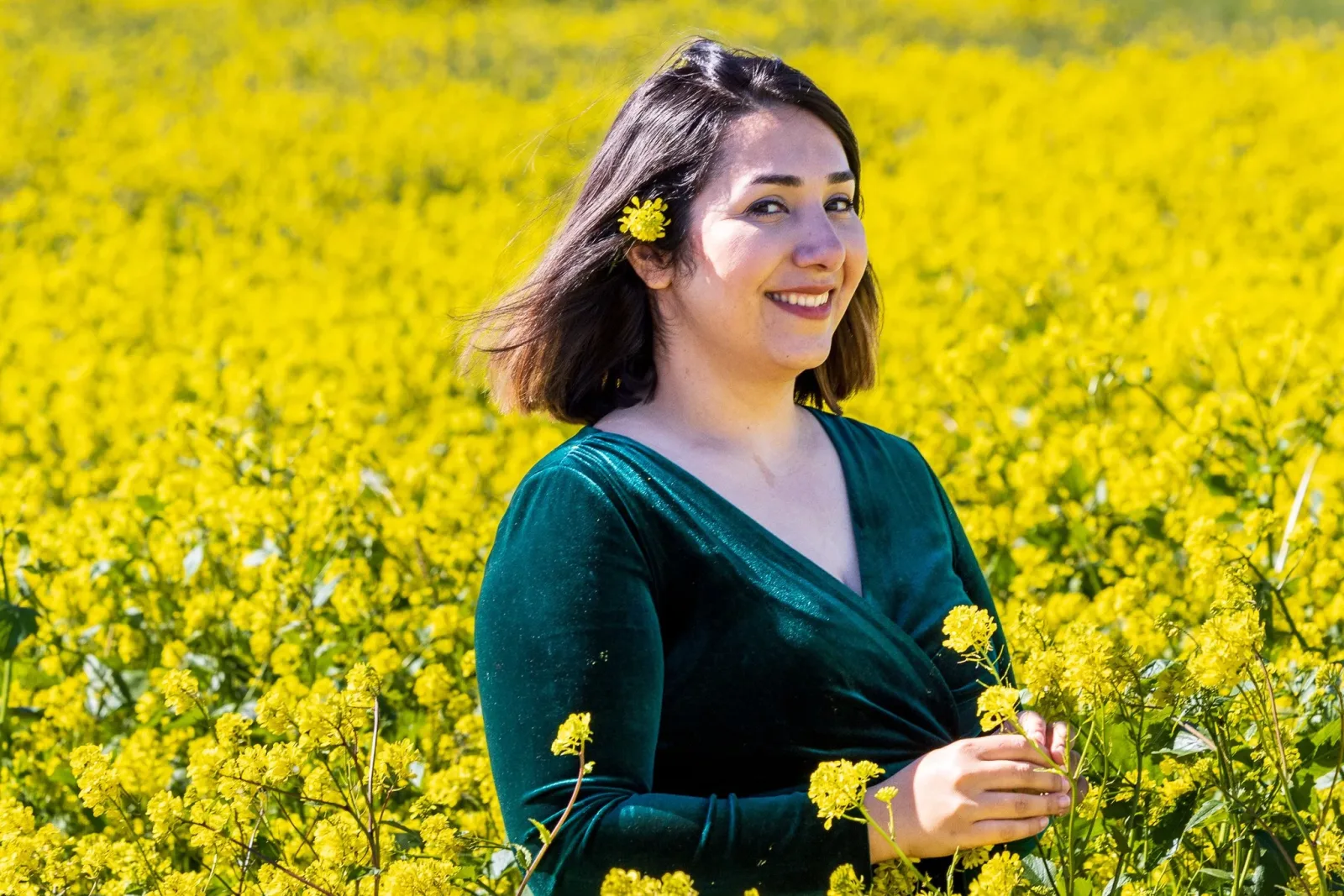 Outdoor headshot of a woman in a golden field at the right hour